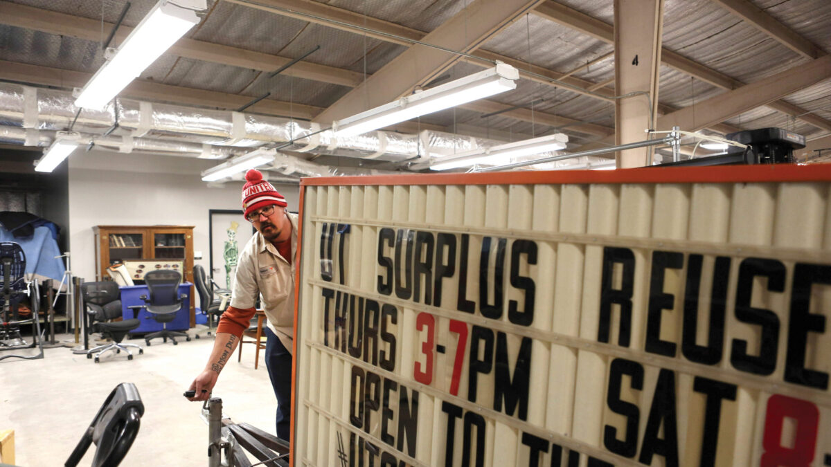 An employee moves the marquee at the Surplus warehouse