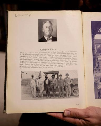 Open book with photos of landscape caretakers from the past