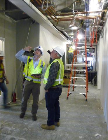 Commissioning specialist does a walk-through inspection of the Norman Hackerman Building.