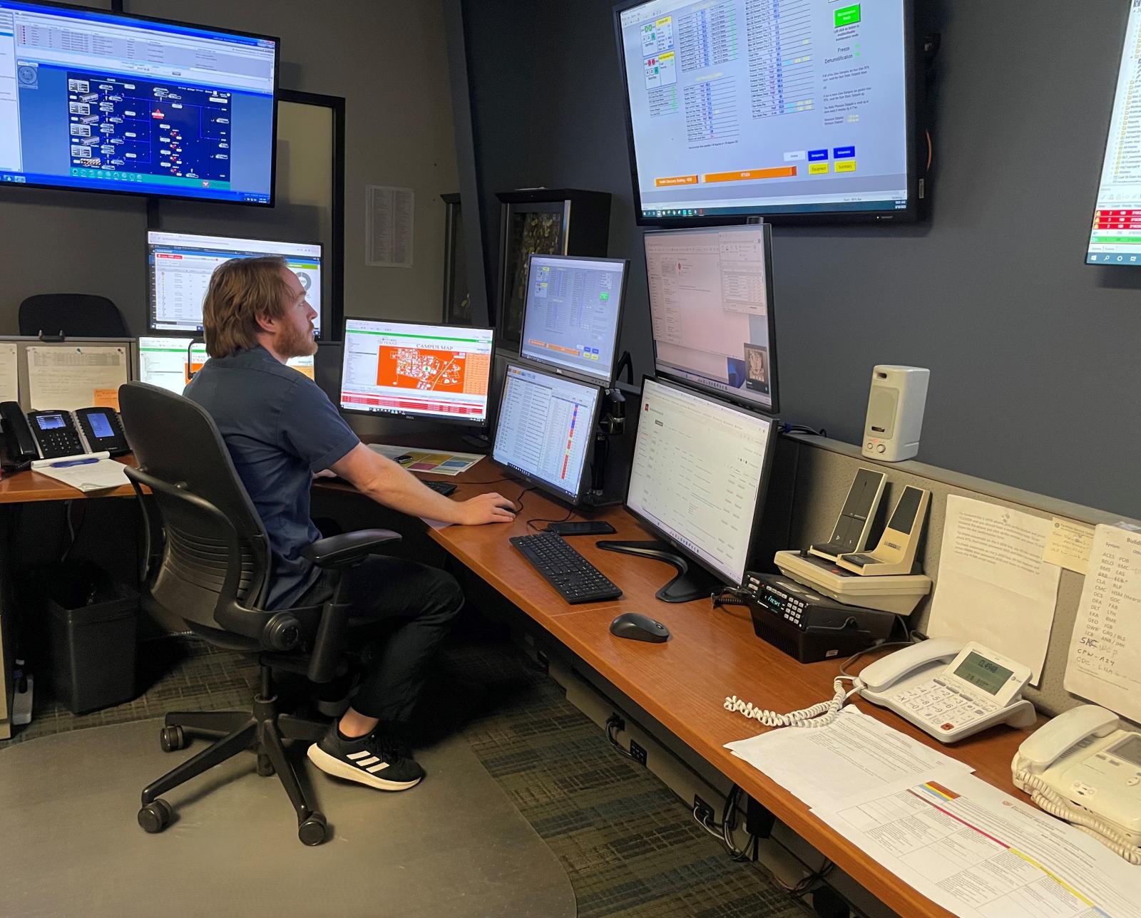 Building Operations Operator Derek Atley monitoring UT facilities online in the centralized Operations center