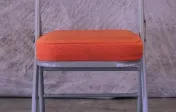 Padded folding orange chair