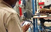 Technicians use hand-held devices to connect to the work order system remotely
