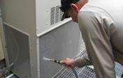 a refrigeration mechanic performs preventive maintenance on an HVAC unit