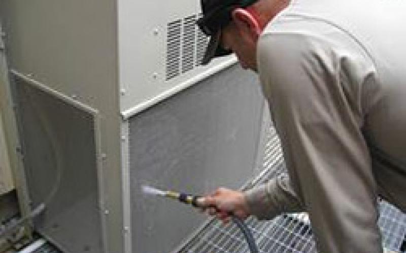 a refrigeration mechanic performs preventive maintenance on an HVAC unit