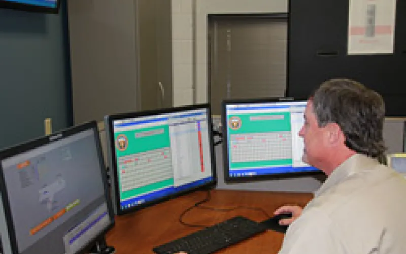 FOM team member monitoring alarms on lcd displays