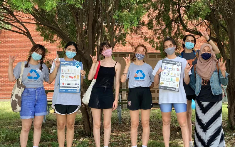 Zero Waste Students holding up new campus bin signage